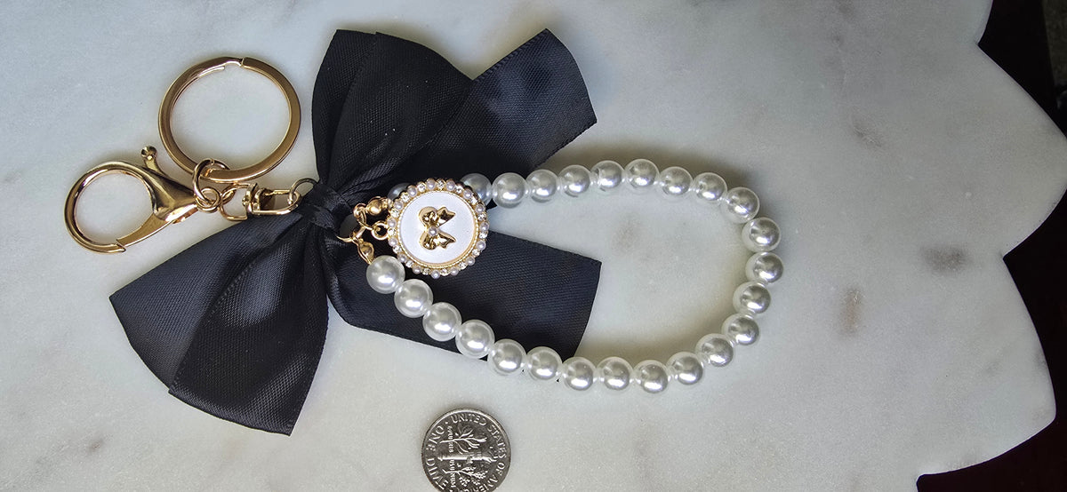 Black Satin Bow Bag Charm Pearl Wristlet Keychain, product photo from Rey & Luck Co