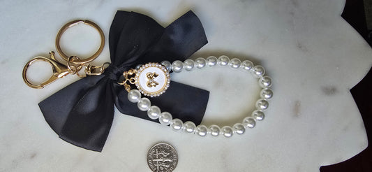 Black Satin Bow Bag Charm Pearl Wristlet Keychain, product photo from Rey & Luck Co