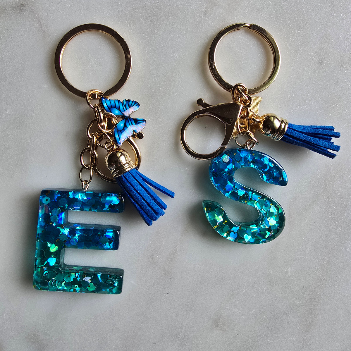 Blue Glitter Resin Initial Keychain Butterfly Tassel product photo from Rey & Luck Co