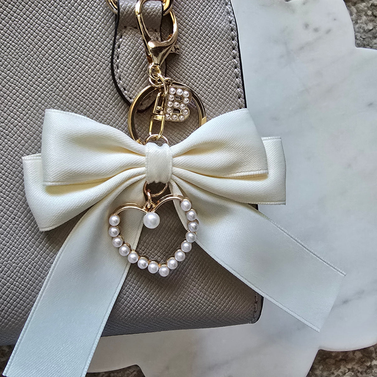 Silky Ribbon Bow Bag Charm Pearl Heart Keychain, product photo from Rey & Luck Co