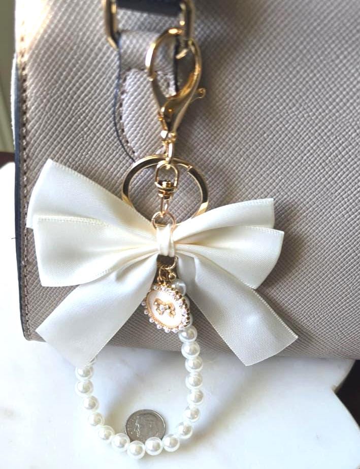 Cream Silky Ribbon Bow Bag Charm Pearl Wristlet product photo 2 from Rey & Luck Co
