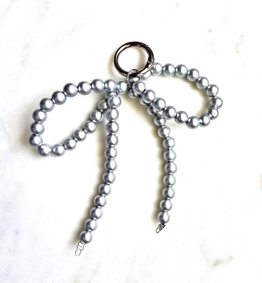 Silver Pearl Bow Bag Charm Elegant Keychain, product photo from Rey & Luck Co