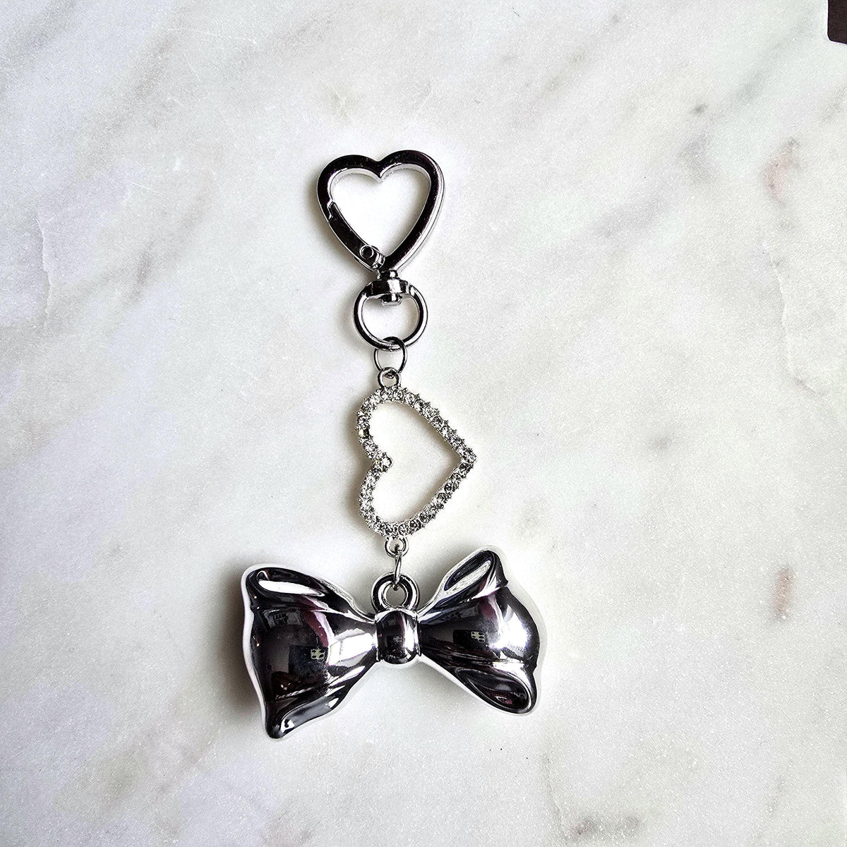 Silver Bow Heart Charm Bag Keychain Elegant product photo from Rey & Luck Co