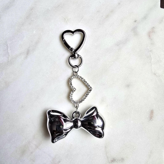 Silver Bow Heart Charm Bag Keychain Elegant product photo from Rey & Luck Co